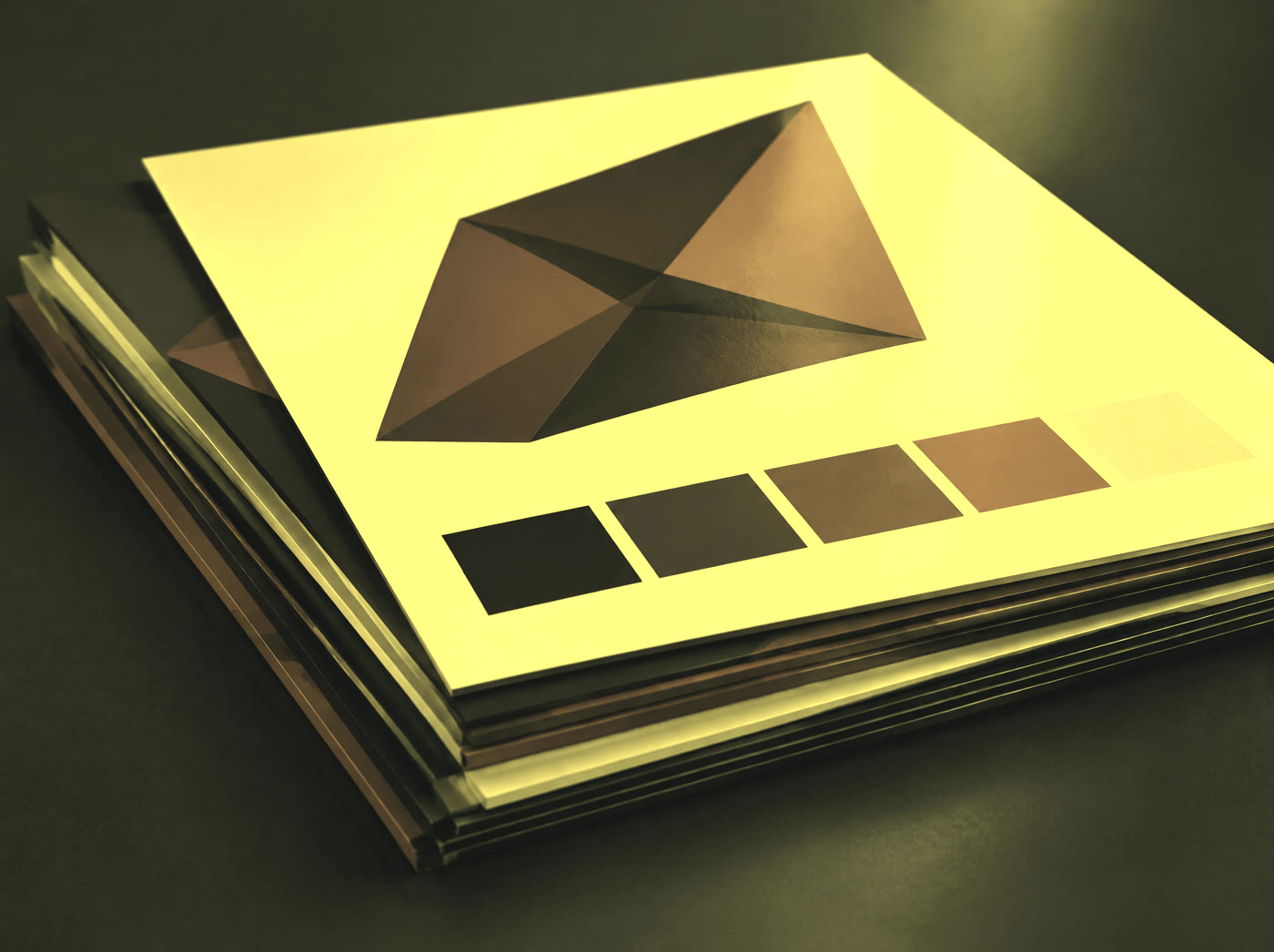 A stack of printed brand boards carrying an abstract faceted mark